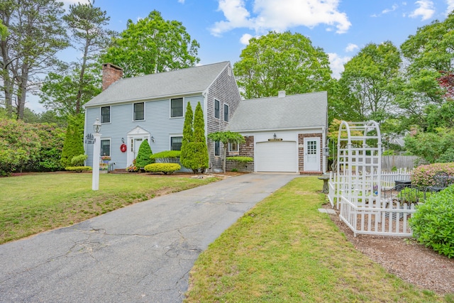 12 Copley Pl, South Yarmouth, MA 02664 - colonial inspired home with a chimney, an attached garage, driveway, and a shingled roof
