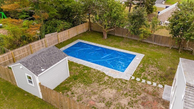view of swimming pool featuring a yard, a fenced backyard, and a fenced in pool