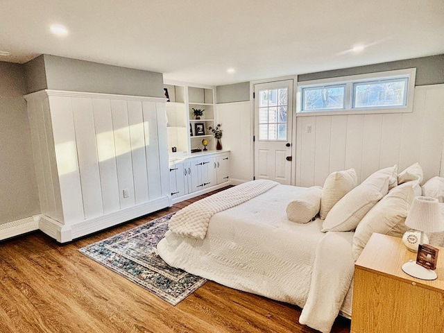 bedroom with dark wood-type flooring