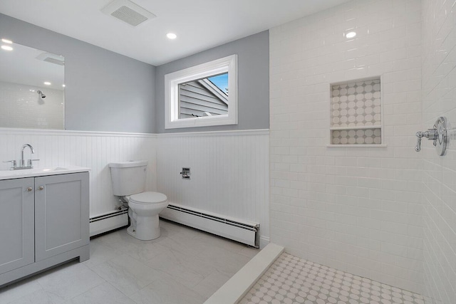 full bathroom featuring toilet, a wainscoted wall, walk in shower, and baseboard heating
