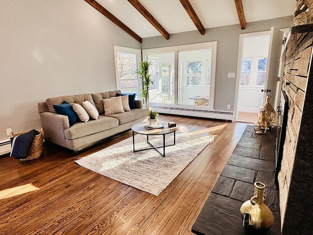 living room with vaulted ceiling with beams, a baseboard heating unit, wood finished floors, and a fireplace