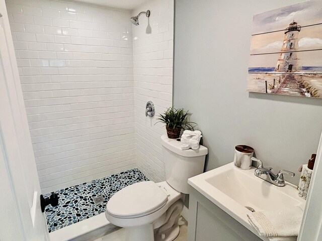 full bathroom with a shower stall, vanity, and toilet