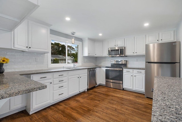 kitchen featuring stainless steel appliances, dark wood-type flooring, white cabinets, and a sink