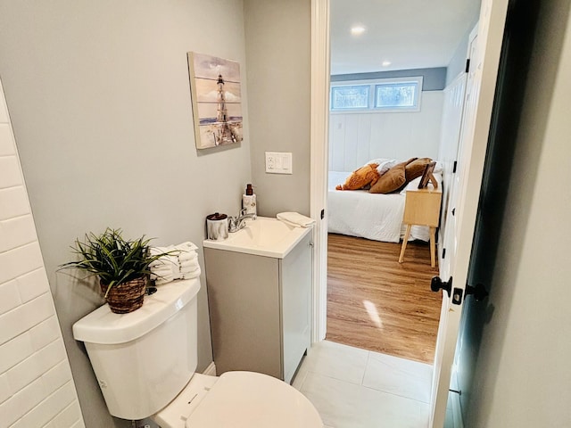 bathroom featuring tile patterned floors, toilet, connected bathroom, and vanity