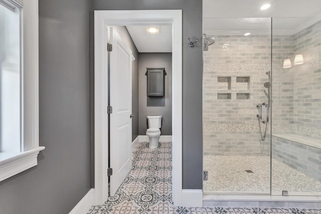 bathroom with a shower with door, toilet, and tile patterned floors