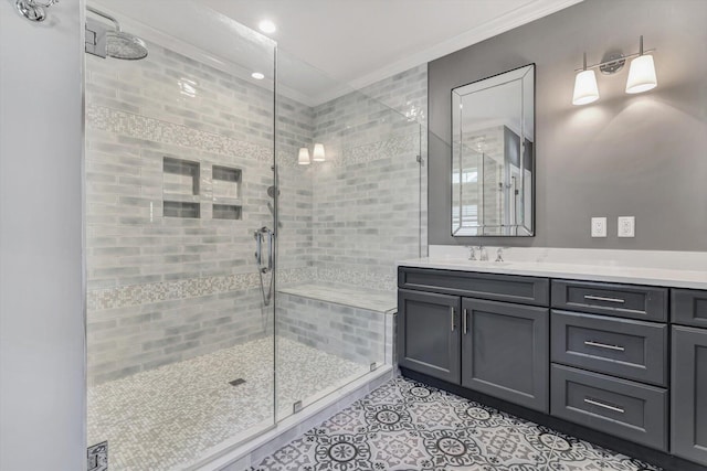 bathroom with tile patterned floors, a shower with door, crown molding, and vanity