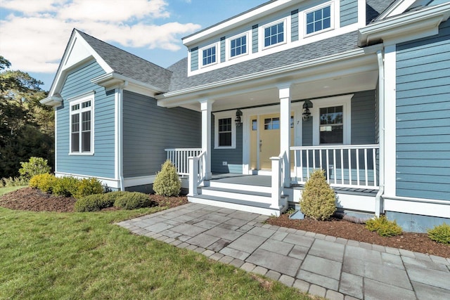 view of front of home with a porch and a front lawn