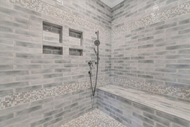 bathroom with tiled shower