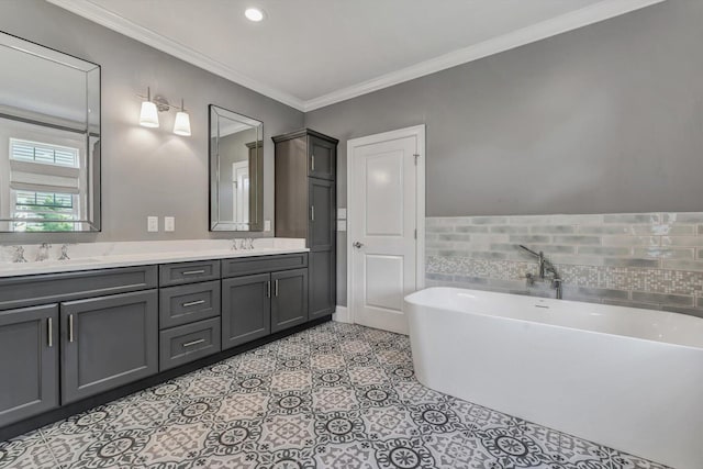 bathroom with vanity, crown molding, tile patterned floors, and a bathing tub