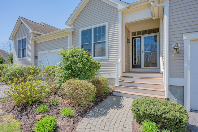 view of exterior entry featuring an attached garage