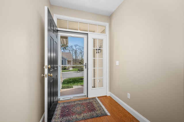 entryway featuring baseboards and wood finished floors
