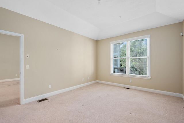 unfurnished room with light colored carpet, baseboards, and visible vents