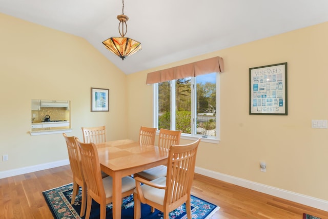 240 Surf Dr, Mashpee, MA 02649 - dining space featuring wood finished floors, baseboards, and lofted ceiling