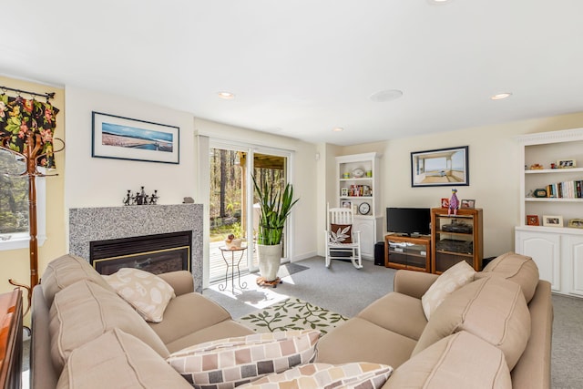 240 Surf Dr, Mashpee, MA 02649 - carpeted living room featuring a glass covered fireplace, baseboards, recessed lighting, and built in shelves