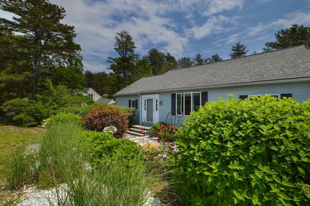 240 Surf Dr, Mashpee, MA 02649 - ranch-style house featuring a storage shed, a garage, asphalt driveway, an outbuilding, and a shingled roof