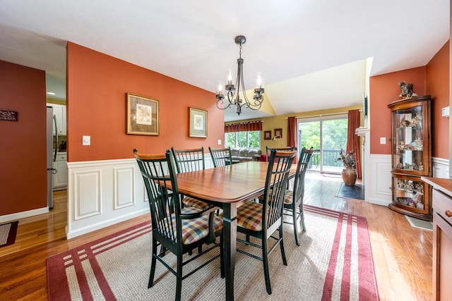 151 Leisure Green Dr N, Mashpee, MA 02649 - dining space featuring light wood finished floors, wainscoting, a decorative wall, and a chandelier