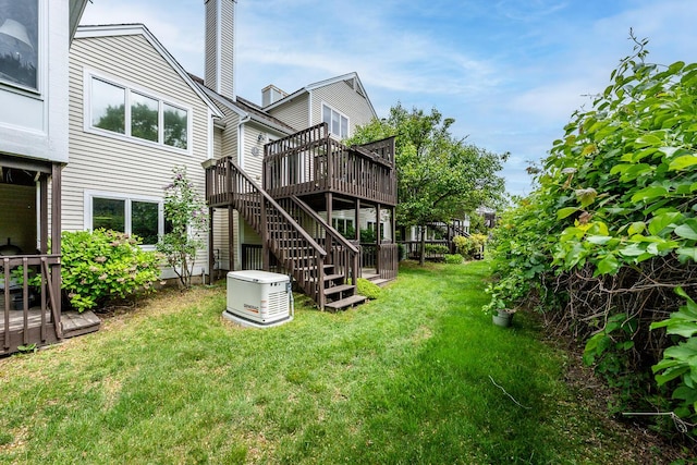 151 Leisure Green Dr N, Mashpee, MA 02649 - back of property with a wooden deck, stairway, a lawn, and a chimney