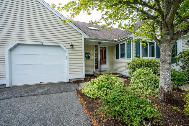 151 Leisure Green Dr N, Mashpee, MA 02649 - ranch-style home featuring roof with shingles, an attached garage, and asphalt driveway