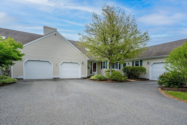 151 Leisure Green Dr N, Mashpee, MA 02649 - ranch-style house featuring driveway, an attached garage, roof with shingles, and a chimney