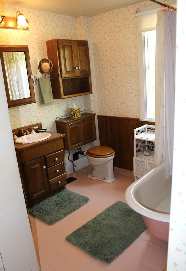 64 Riverside Dr, West Harwich, MA 02671 - full bathroom with wallpapered walls, a freestanding bath, vanity, and toilet
