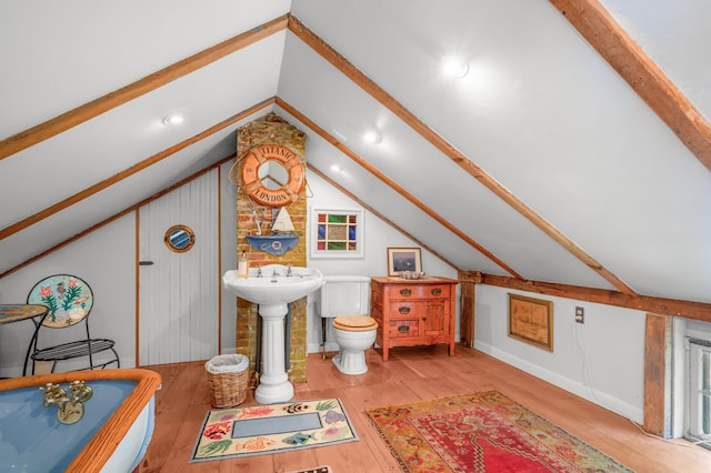 64 Riverside Dr, West Harwich, MA 02671 - full bathroom with lofted ceiling, hardwood / wood-style floors, a soaking tub, and toilet