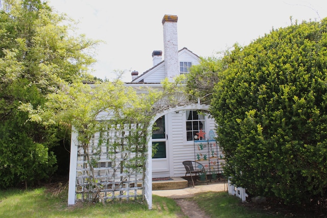 64 Riverside Dr, West Harwich, MA 02671 - view of side of home with a chimney