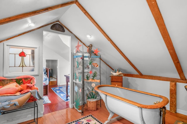 64 Riverside Dr, West Harwich, MA 02671 - bathroom with lofted ceiling, wood finished floors, and a soaking tub