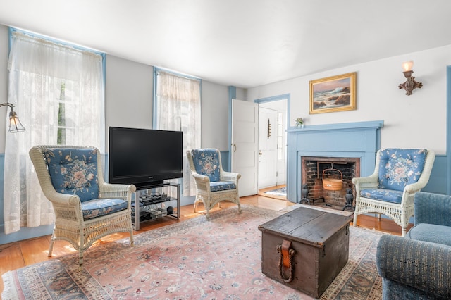 64 Riverside Dr, West Harwich, MA 02671 - living area featuring wood finished floors and a fireplace with flush hearth