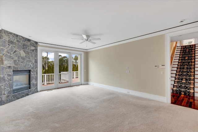 24 Pleasant Park Dr, Mashpee, MA 02649 - unfurnished living room featuring a ceiling fan, carpet flooring, a stone fireplace, and ornamental molding