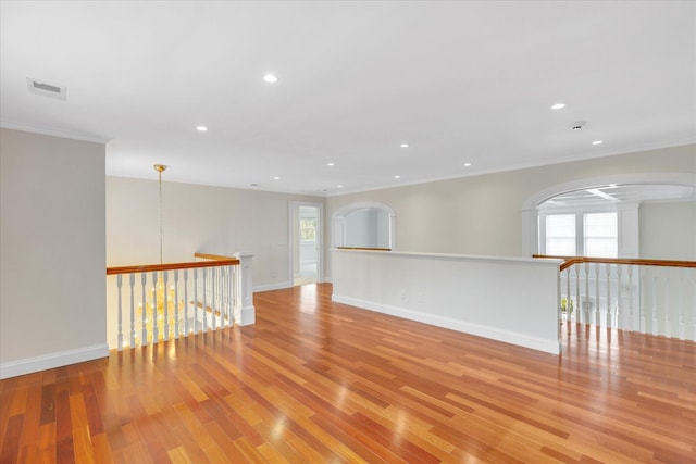 24 Pleasant Park Dr, Mashpee, MA 02649 - unfurnished room featuring wood finished floors, ornamental molding, recessed lighting, and arched walkways