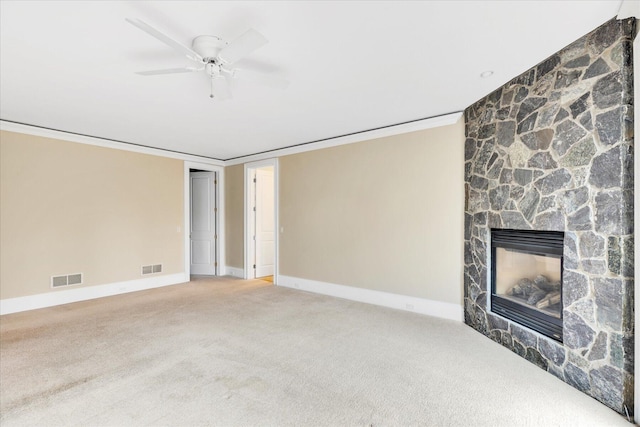 24 Pleasant Park Dr, Mashpee, MA 02649 - unfurnished living room with carpet floors, a stone fireplace, ornamental molding, and a ceiling fan