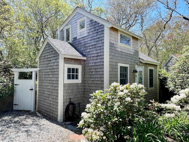 view of side of home with a shingled roof