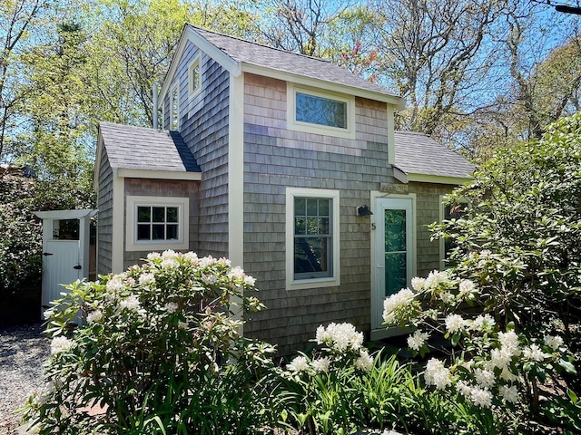 view of property exterior featuring a shingled roof