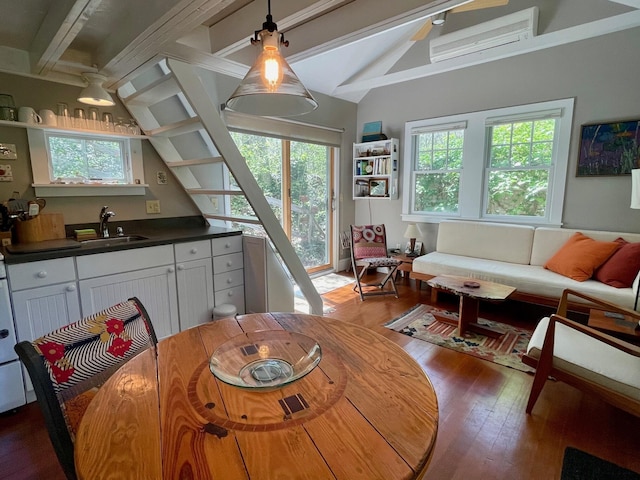 dining space featuring dark wood-style floors and a wall mounted AC