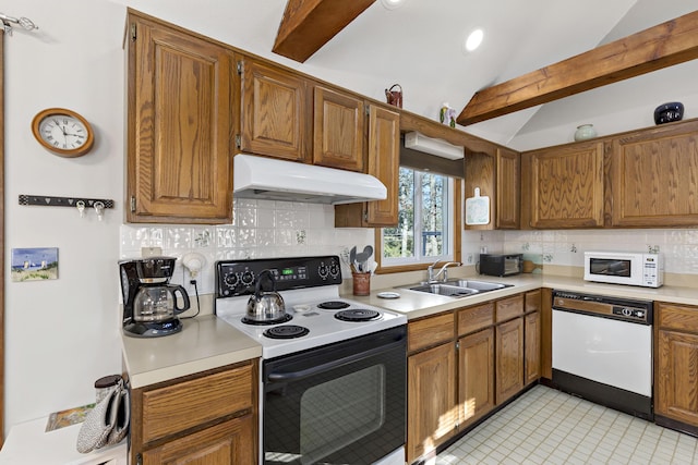 kitchen featuring vaulted ceiling with beams, under cabinet range hood, white appliances, a sink, and light countertops