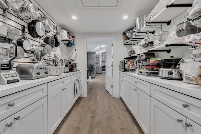 kitchen featuring white cabinets and light hardwood / wood-style flooring