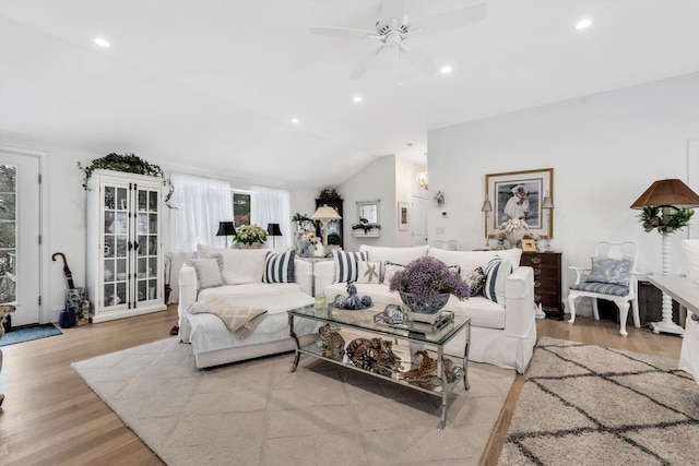 living room with light hardwood / wood-style floors, vaulted ceiling, ceiling fan, and french doors