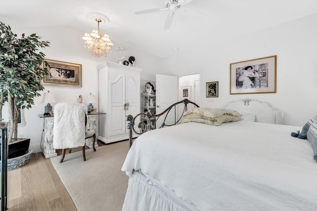 bedroom with light hardwood / wood-style floors, vaulted ceiling, and ceiling fan