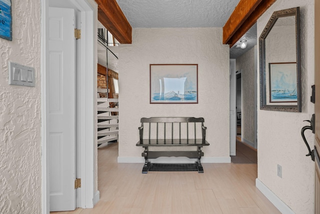 133 Breakwater Shores Dr, Hyannis, MA 02601 - hallway featuring baseboards, a textured wall, wood finished floors, and a textured ceiling