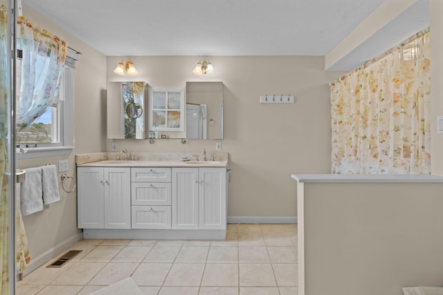 133 Breakwater Shores Dr, Hyannis, MA 02601 - full bath with baseboards, visible vents, a sink, and tile patterned floors