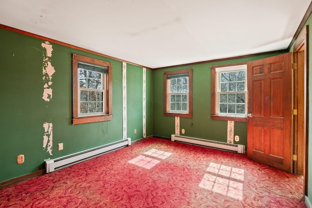 spare room featuring a baseboard radiator, baseboards, carpet flooring, and crown molding