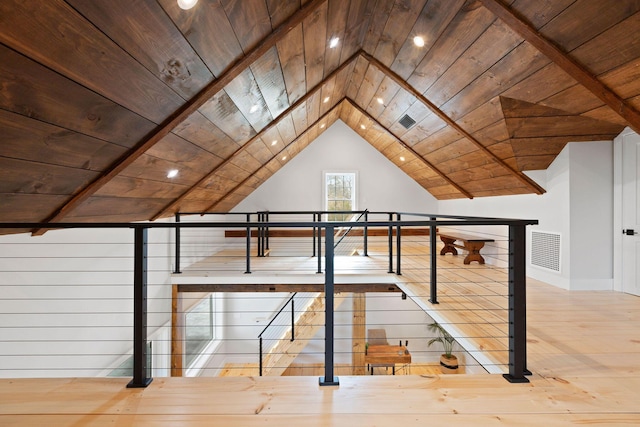 additional living space with wood ceiling, vaulted ceiling, wood finished floors, and visible vents