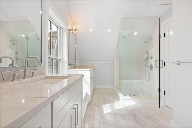 bathroom with marble finish floor, a shower stall, two vanities, and a sink