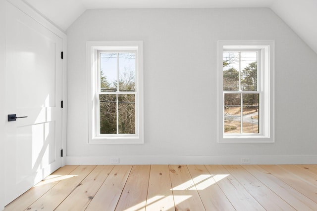 bonus room featuring lofted ceiling, baseboards, and hardwood / wood-style floors