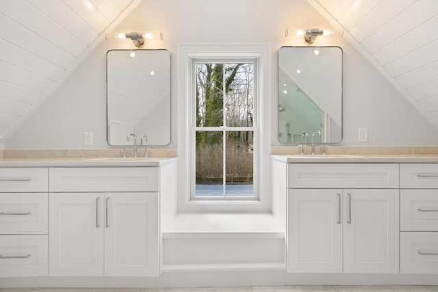 full bathroom with two vanities, vaulted ceiling, wooden ceiling, and a sink