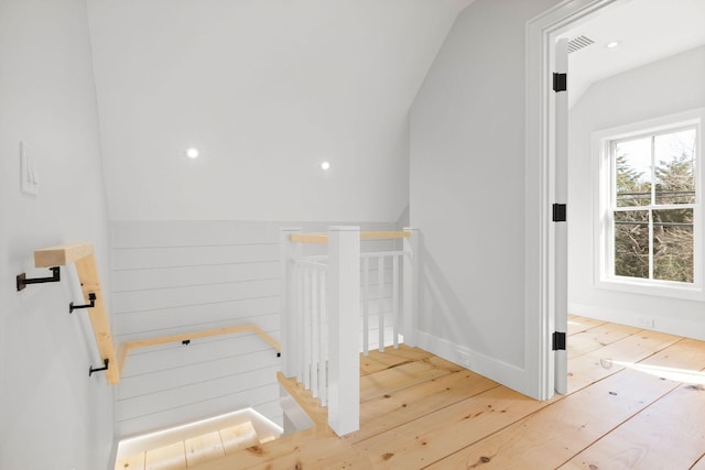 stairway with visible vents and hardwood / wood-style floors