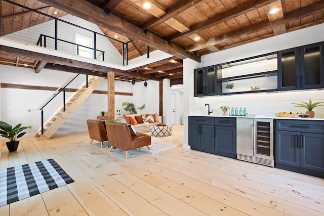 bar featuring wood ceiling, wine cooler, light wood-style flooring, wet bar, and beam ceiling