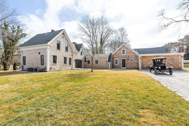 exterior space featuring a chimney and a yard