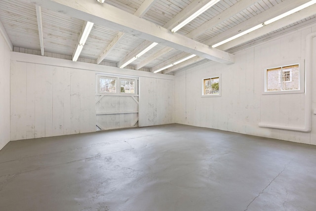 empty room with concrete floors and a wealth of natural light