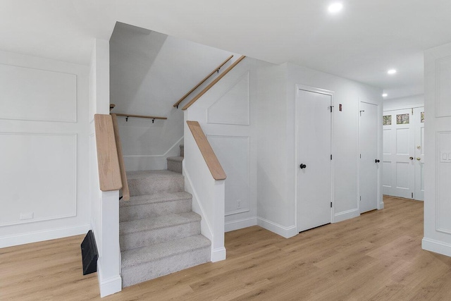 stairs with hardwood / wood-style floors